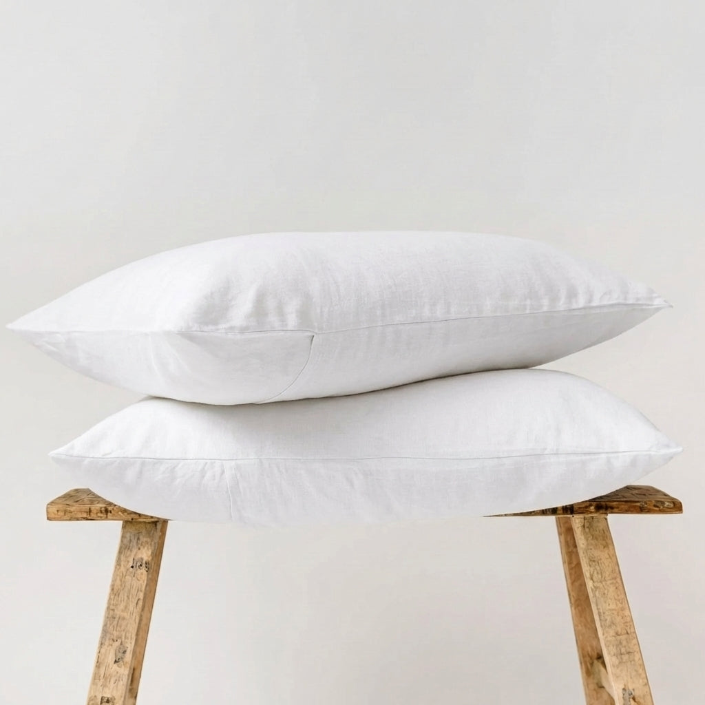 Two Lys Studio linen pillowcases resting on a wooden chair